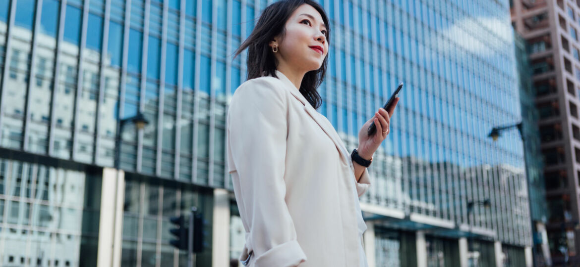 Successful Businesswoman Looking Away While Using Smart Phone
